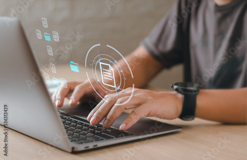 Close-up Office worker typing laptop keyboard showing document management or database, concept of digital document storage system technology the organization's business efficiency with technology