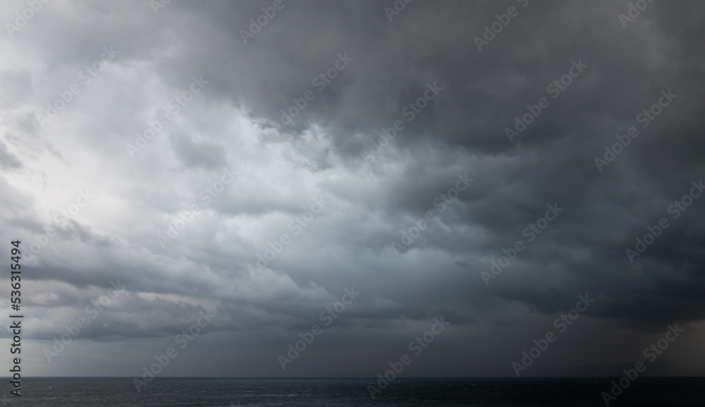 Dramatic dark stormy sky over sea water, natural photo Dramatic dark stormy sky over sea water, natural photo