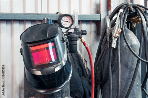 equipment for gas welding in the workshop: mask, cylinders with a pressure gauge, hoses photo