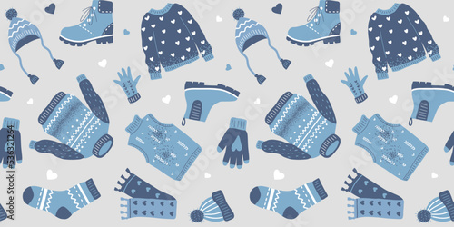 Seamless pattern with warm winter clothes. Knitted sweater, hat, gloves, boots, scarf and socks