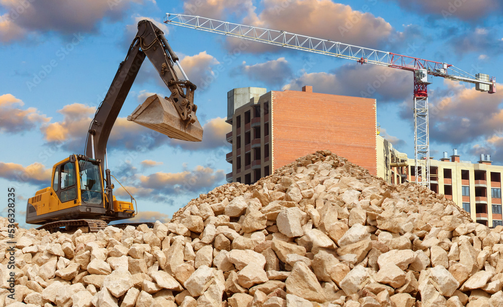 Construction works. Construction of multistorey block. Excavator on on