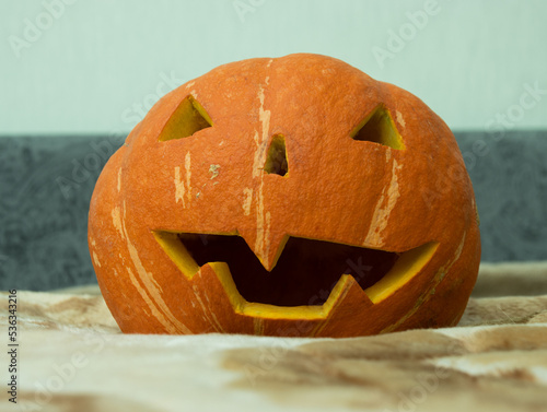 Pumpkin, close-up of dirty Jack-o-lantern. Orange decorative pumpkin. Halloween party concept.