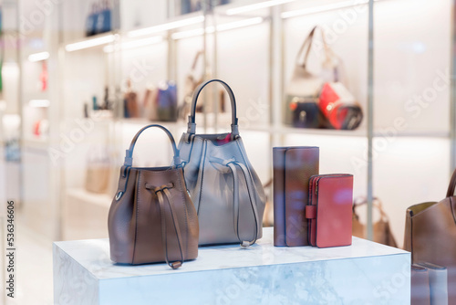 Stylish leather women's bags in a shop window. Expensive elegant accessories.