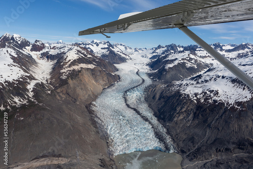 Airplane wing and mountain landscape in Glacier Bay National Park photo