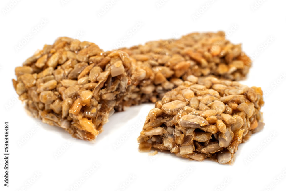 Candy or candy bar made from sweet sunflower seeds on a white background. seeds Candy or candy bar made from sweet sunflower seeds on a white background. seeds