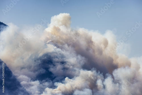 BC Forest Fire and Smoke over the mountain near Hope during a hot sunny summer day. British Columbia, Canada. Wildfire natural disaster