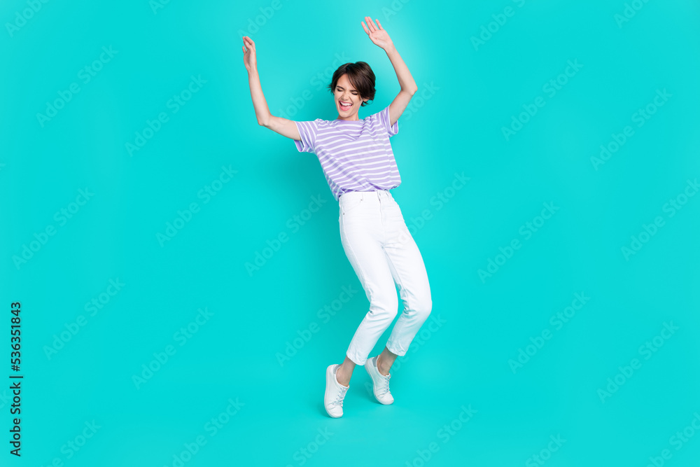 Fototapeta premium Full length photo of pretty funky girl dressed purple t-shirt dancing having fun isolated teal color background