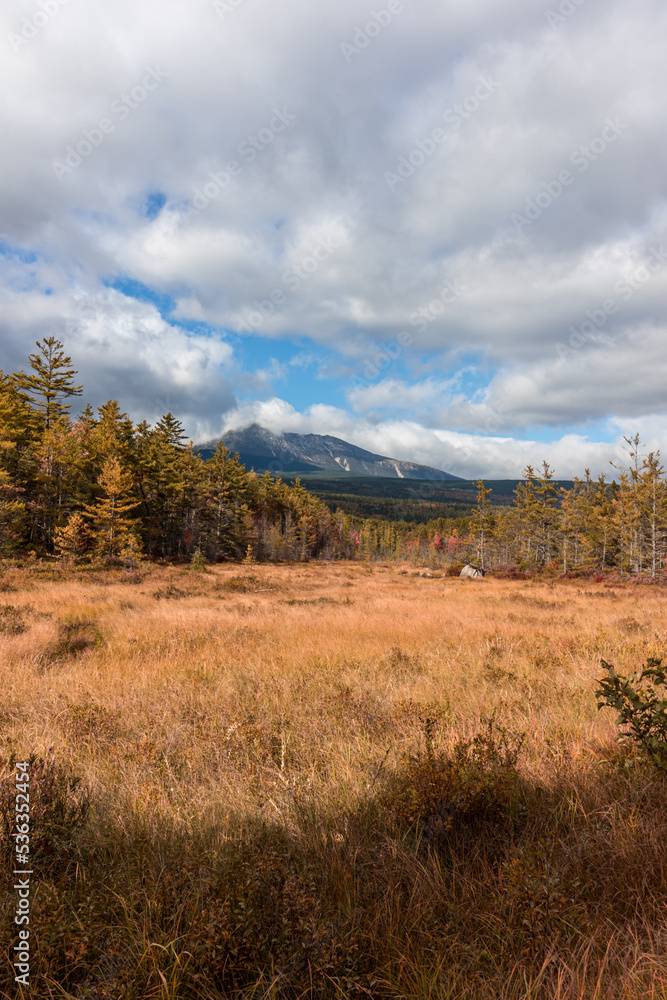 Baxter Peak from Tote Road in Maine with brilliant fall foliage on a mostly cloudy day Baxter Peak from Tote Road in Maine with brilliant fall foliage on a mostly cloudy day