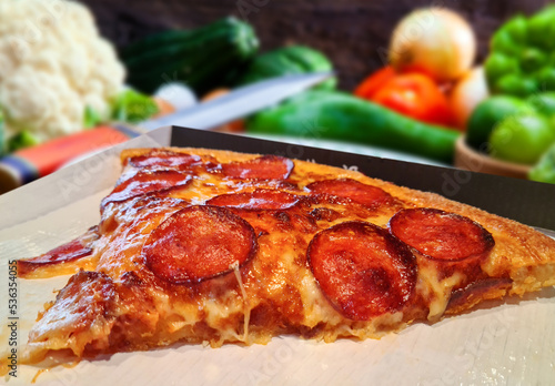 Pizza with pepperoni  mozzarella and tomatoes