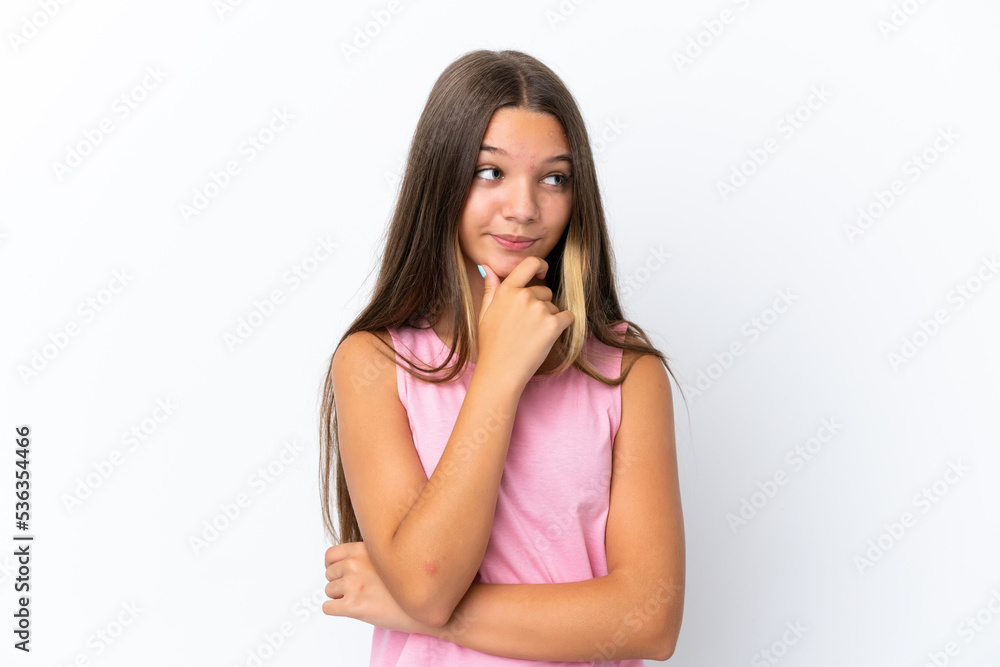 Little caucasian girl isolated on white background thinking an idea while looking up Little caucasian girl isolated on white background thinking an idea while looking up