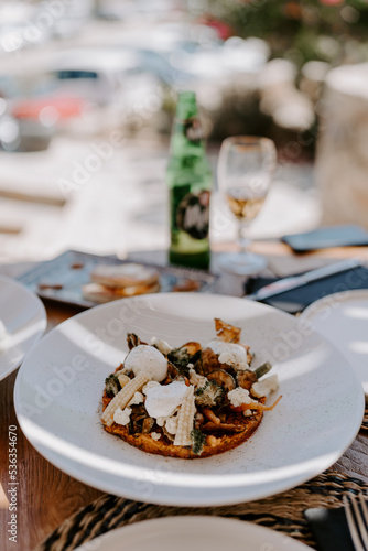 Greek food served in a traditional Greek restaurant  greek salad  vegetables  greens  plates  beer