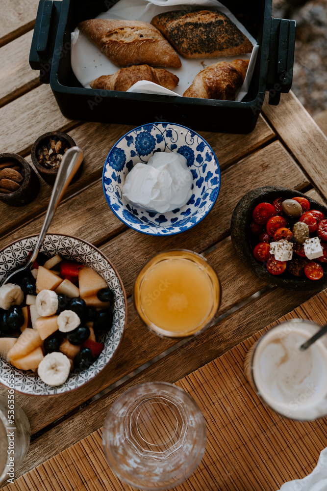 Greek food served in a traditional Greek restaurant: fruit salad, yoghurt, orange juice, croissants, pastry Greek food served in a traditional Greek restaurant: fruit salad, yoghurt, orange juice, croissants, pastry