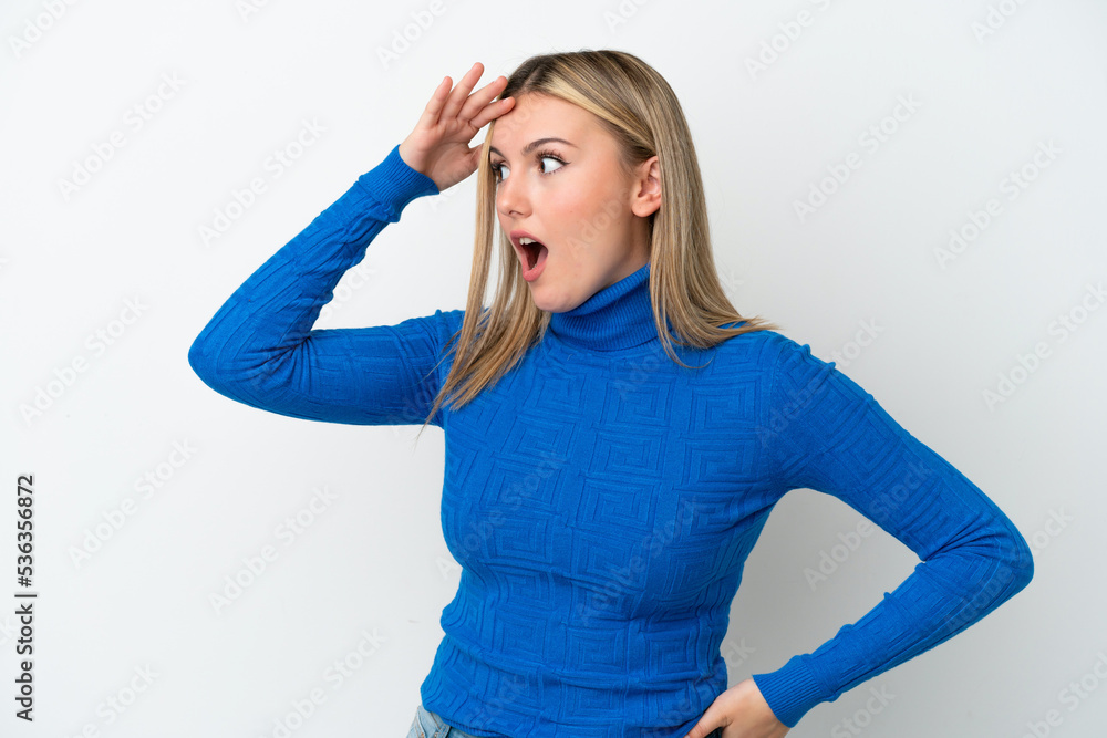 Young caucasian woman isolated on white background with surprise expression while looking side Young caucasian woman isolated on white background with surprise expression while looking side