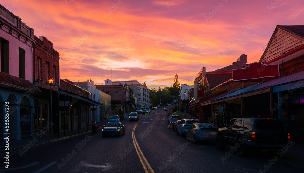 Sunset over a small western town and curved street in autumn