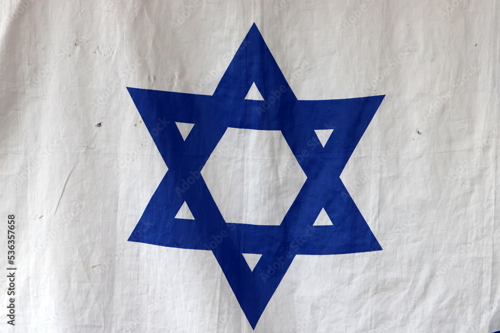 The blue and white flag of Israel with the six-pointed Star of David. The blue and white flag of Israel with the six-pointed Star of David.