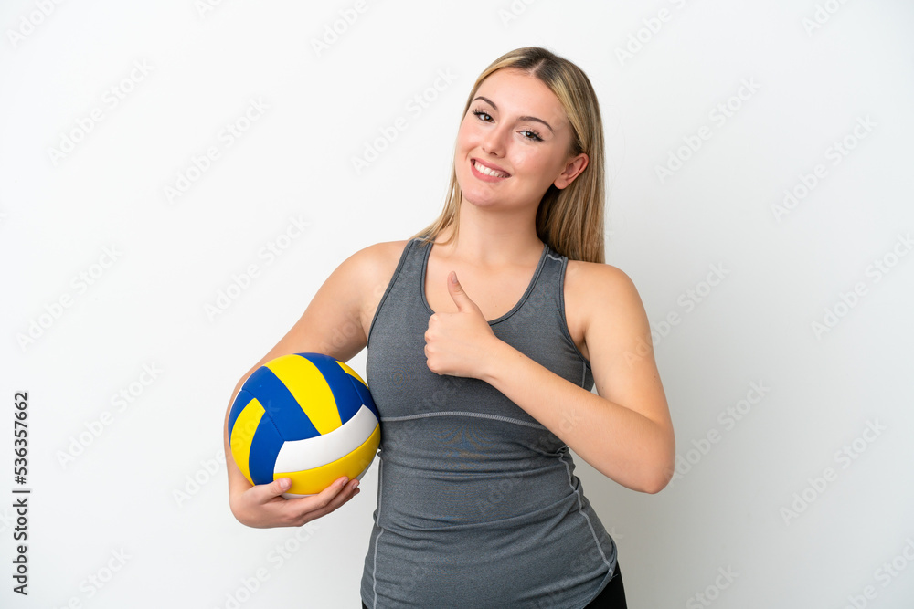 Young caucasian woman playing volleyball isolated on white background giving a thumbs up gesture