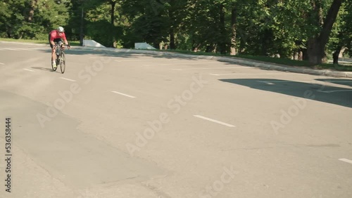 Wallpaper Mural Serious athlete wearing helmet and eyeglasses cycling down the road outdoors Torontodigital.ca