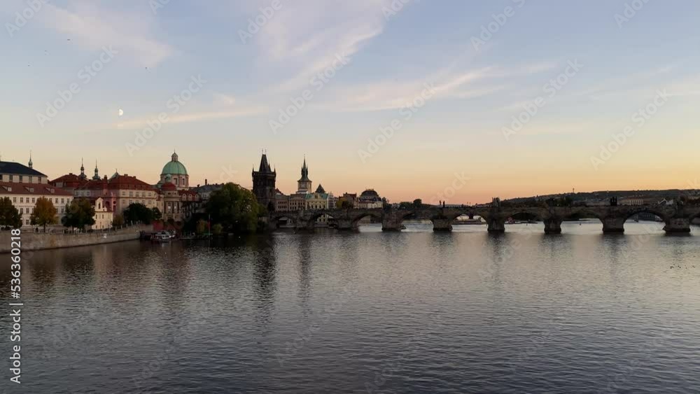 Orange sunset on the Vltava River with a view of the Charles Bridge. Orange sunset on the Vltava River with a view of the Charles Bridge.