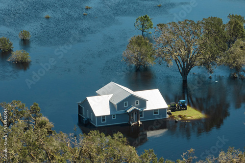 Quadro em tela Surrounded by hurricane Ian rainfall flood waters home in Florida residential area