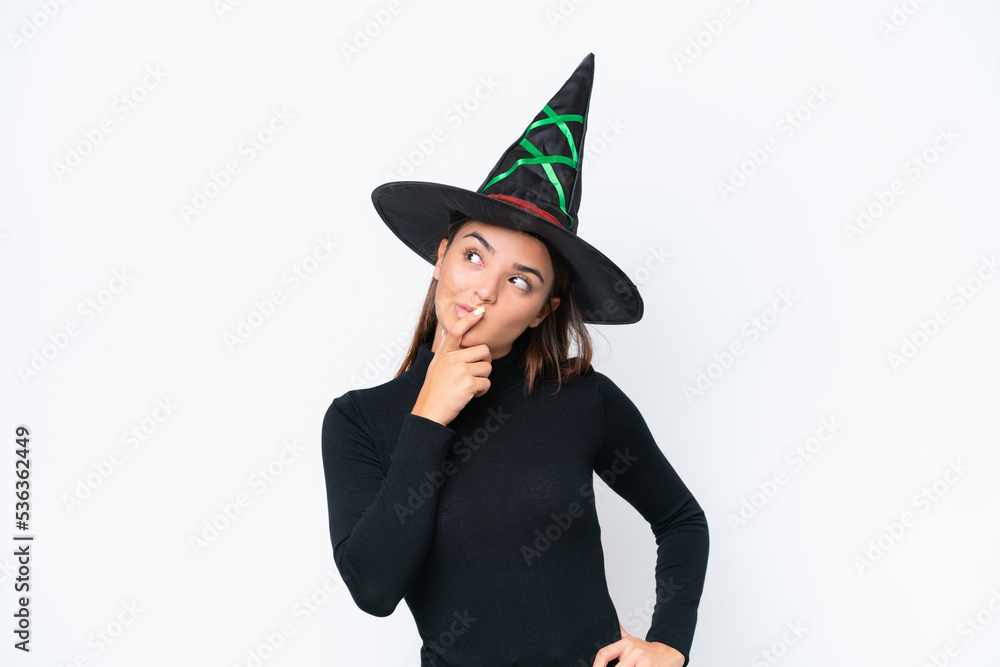 Young caucasian woman costume as witch isolated on white background having doubts and with confuse face expression Young caucasian woman costume as witch isolated on white background having doubts and with confuse face expression