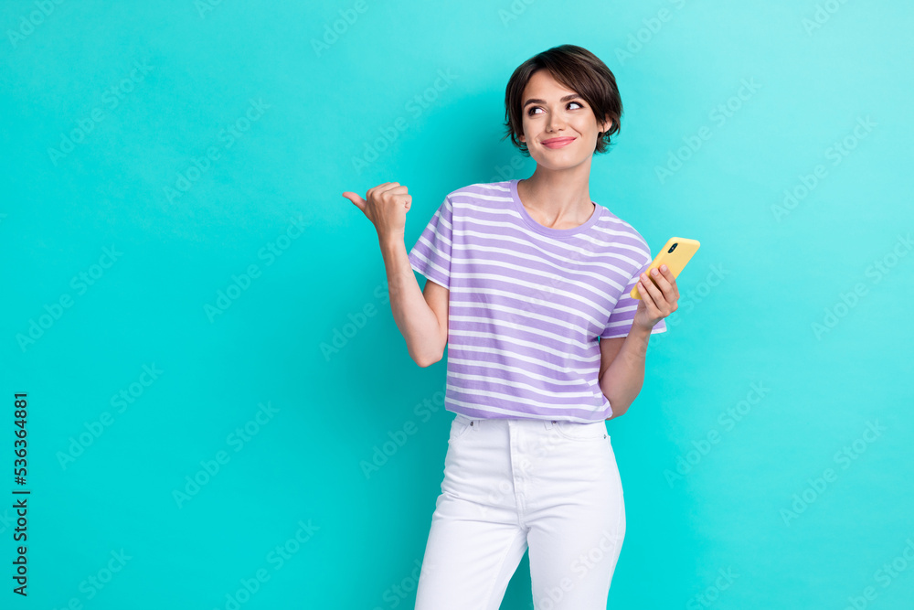 Photo of pretty lady arm direct look empty space hold modern telephone recommend gadget device shop sale isolated on cyan color background Photo of pretty lady arm direct look empty space hold modern telephone recommend gadget device shop sale isolated on cyan color background