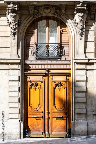 Paris, an ancient sculpted door, beautiful facade in a luxury neighborhood
 photo