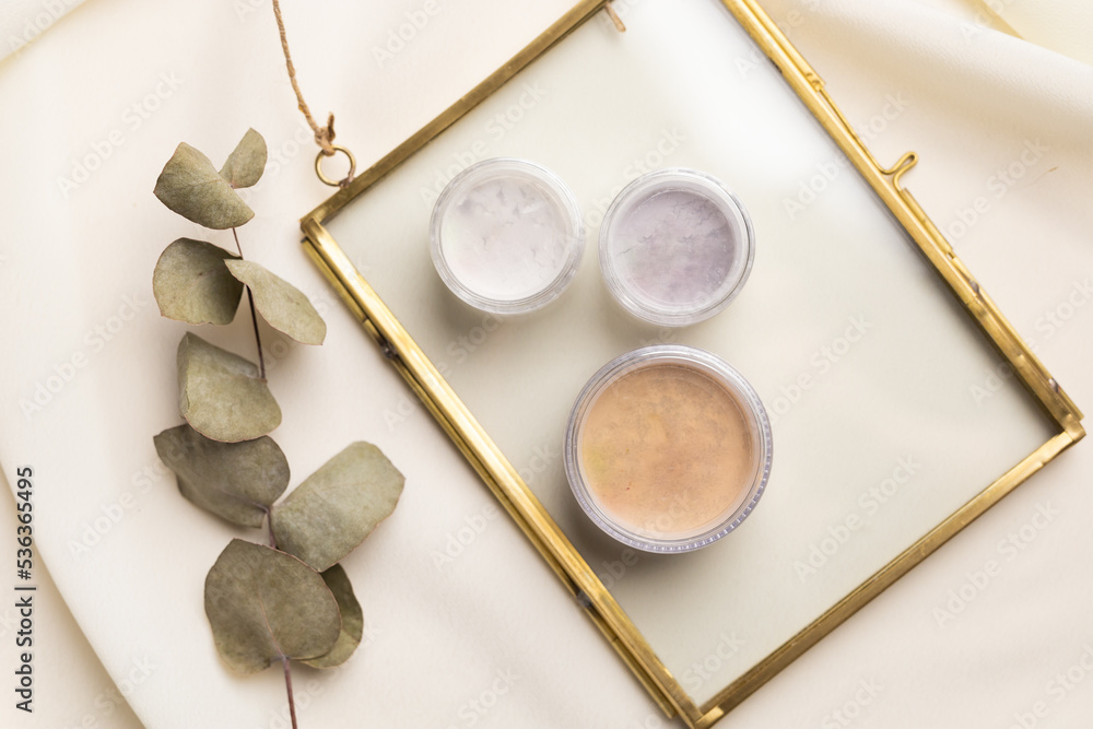 Face powder for make up in boxes on natural background with dried flowers. Aesthetics of makeup artist cosmetic beauty top view Face powder for make up in boxes on natural background with dried flowers. Aesthetics of makeup artist cosmetic beauty top view