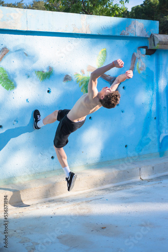 young guy doing parkour in the urban area