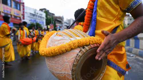 Devotees play dhol or drum and dance during rath yatra festival. photo