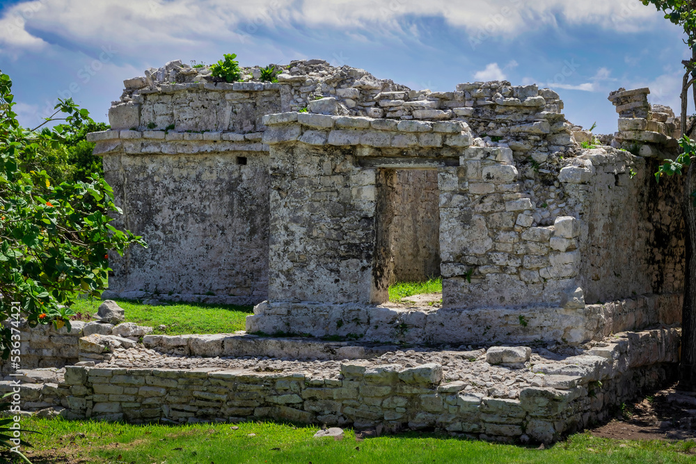 Tulum ruins Mayan site with temple ruins pyramids and artifacts in the tropical natural jungle forest palm and seascape panorama view in Tulum Mexico.
