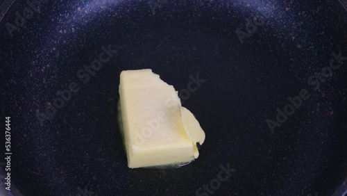 butter melts and slides in the pan. melts a piece of butter