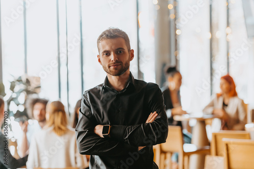 Cheerful self confident professional businessman with crossed hands portrait. photo