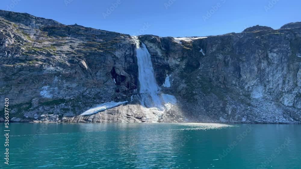 Spectacular glacial waterfall on the west coast of Greenland, between Ilulissat and the Eqi Glacier Camp Spectacular glacial waterfall on the west coast of Greenland, between Ilulissat and the Eqi Glacier Camp