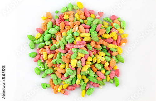 Colorful puffed rice sweets. Pile of rainbow drops cand isolated on white background photo