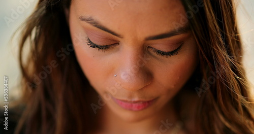 Pensive thoughtful latina young woman looking up thinking