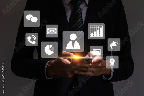 Contact Us. business man in suit hand touching on mobile smart phone with virtual social media icon diagram, business finance, internet data technology, digital marketing, social network concept