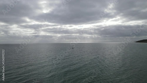 Drone view of a boat sailing on the ocean of Maslin Beach under the cloudy sky photo