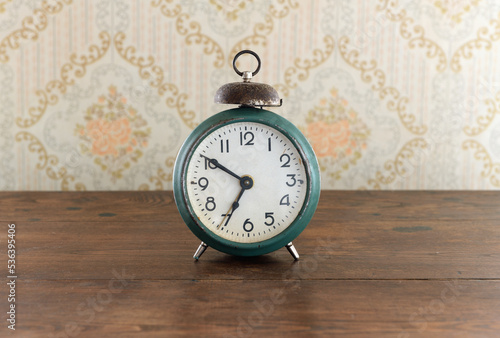 Vintage Alarm black clock.Retro clock on a wooden table.7 am.