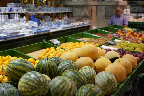 Greek man selling fruits and vegetables at the weekly market on the island of Kos in Greece