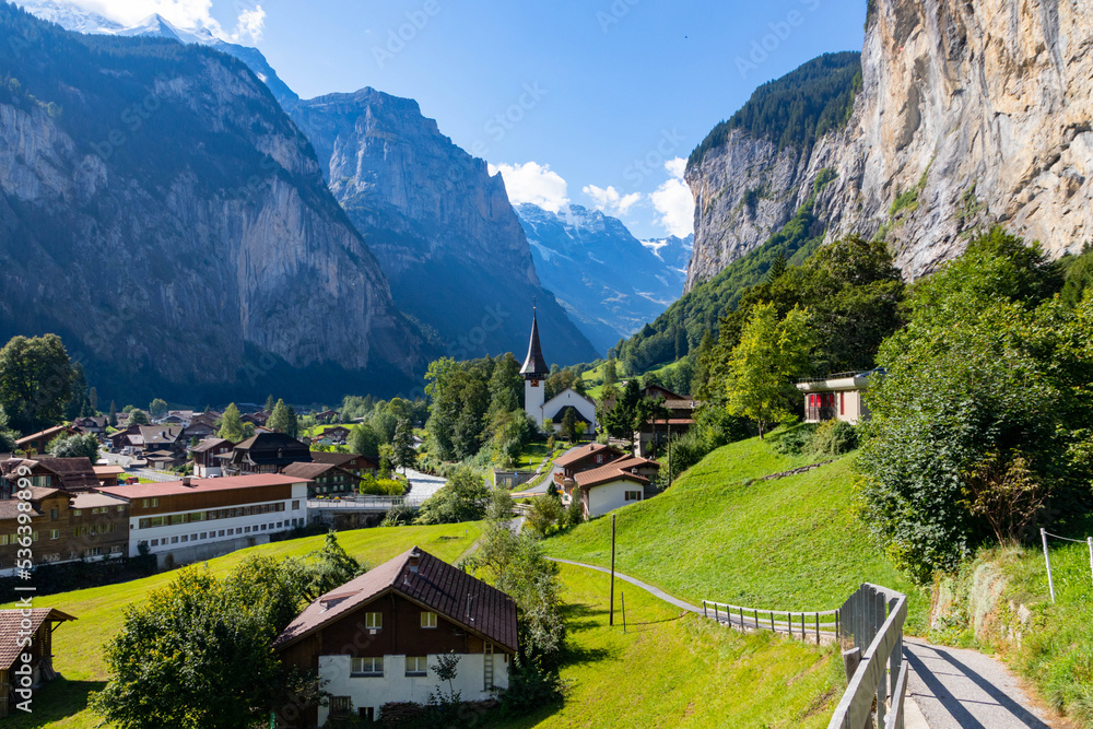 View of Lauterbrunnen Swiss town with Staubbach waterfall on its side. This village is one of the most touristic places in Switzerland