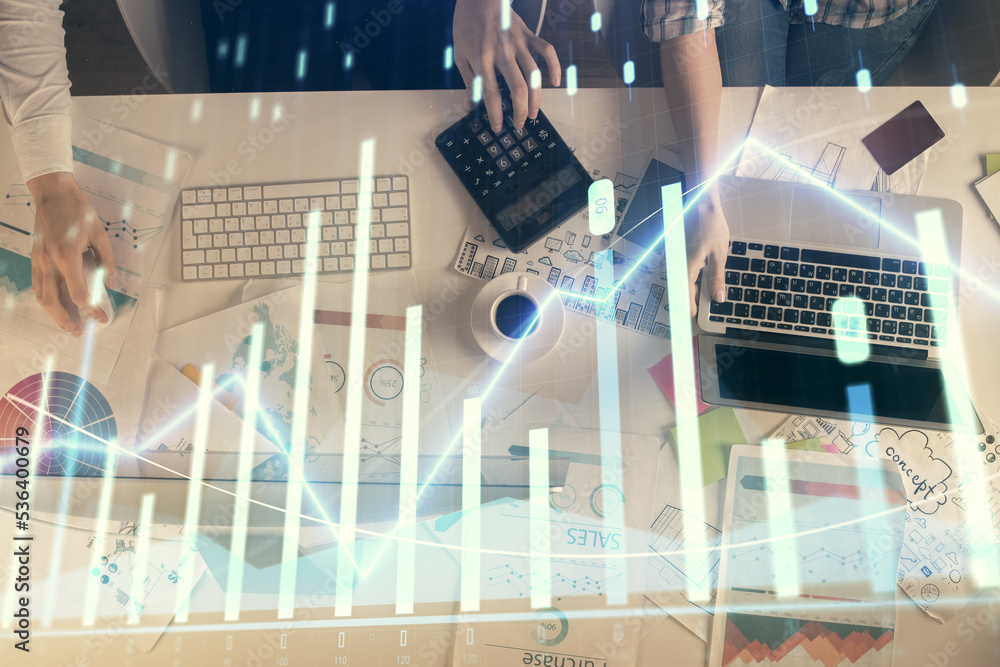 Multi exposure of man and woman working together and financial chart hologram. Business concept. Computer background. Multi exposure of man and woman working together and financial chart hologram. Business concept. Computer background.