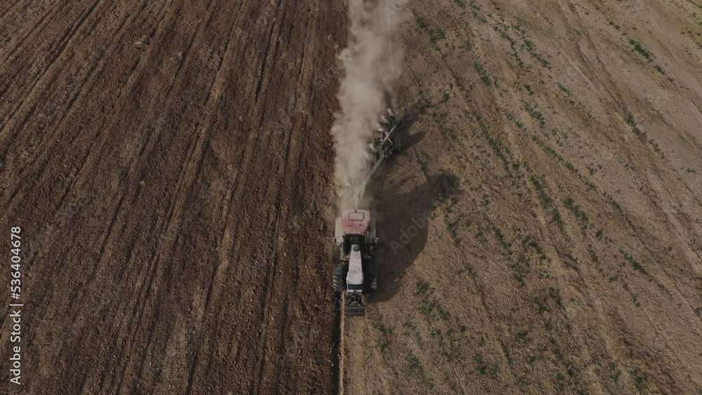 Tractor with disc cultivator on field cultivating. Disk harrow on