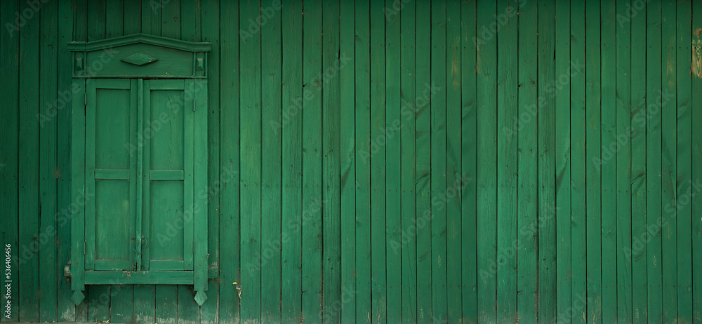 Horizontal banner with a wooden wall and a closed wooden window with shutters. Green wooden fence. Place for text. Old Russian village house in the Kazakh city of Pavlodar. Vintage. Copyspace Horizontal banner with a wooden wall and a closed wooden window with shutters. Green wooden fence. Place for text. Old Russian village house in the Kazakh city of Pavlodar. Vintage. Copyspace