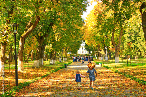 great autumnal park and people in excursion in historical estate of Kachanivka