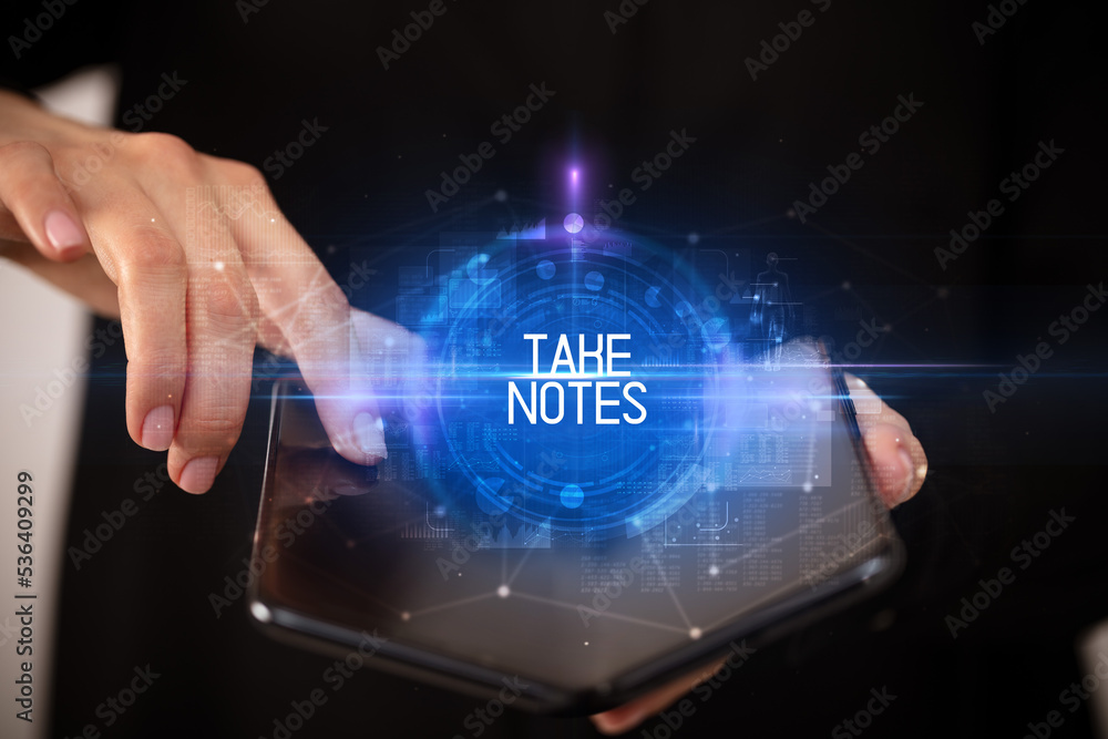 Young man holding a foldable smartphone Young man holding a foldable smartphone
