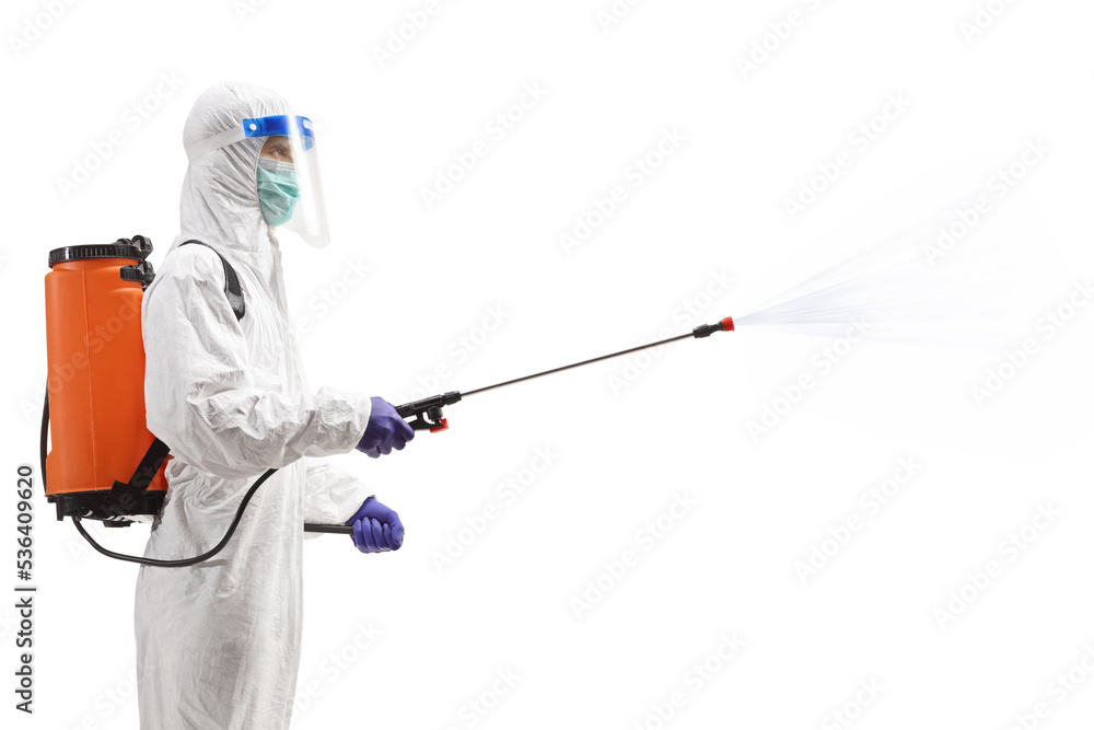 Man in a hazmat suit spraying a disinfectant