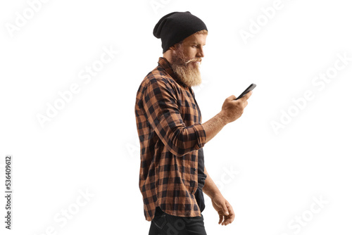 Young man in checkered shirt and jeans using a mobile phone © Ljupco Smokovski