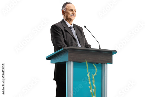 Mature businessman giving a speech on a podium and smiling photo