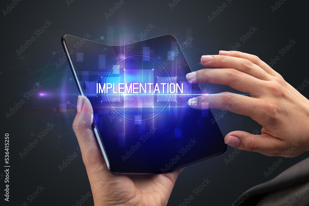 Businessman holding a foldable smartphone Businessman holding a foldable smartphone