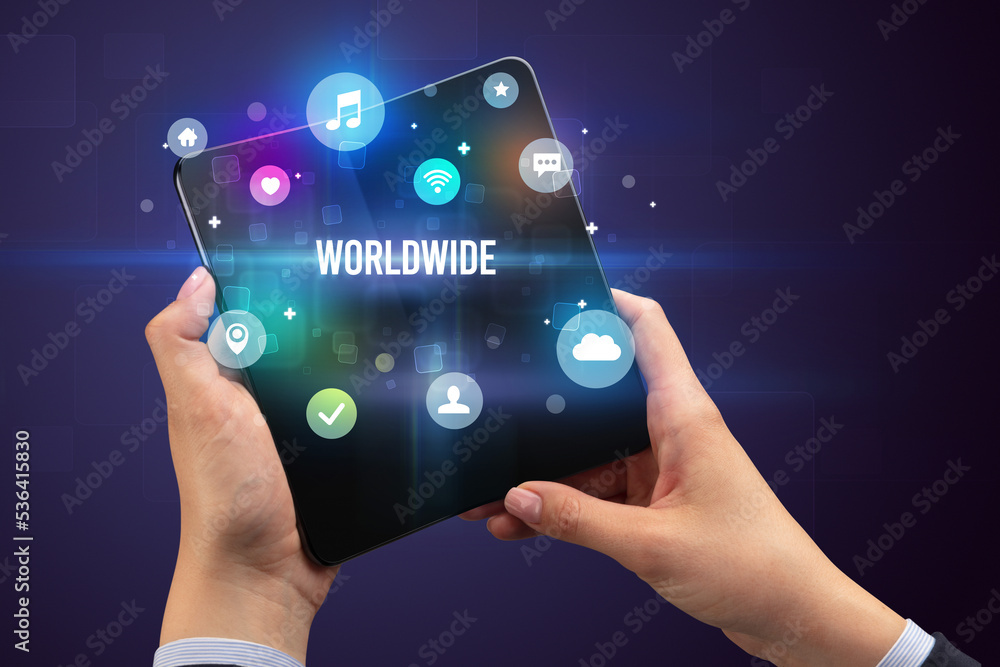 Businessman holding a foldable smartphone Businessman holding a foldable smartphone